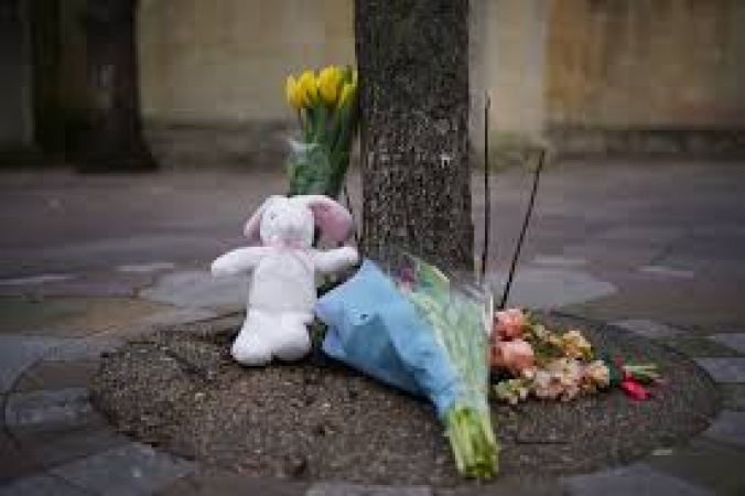 Woman arrested after baby boy found dead by church