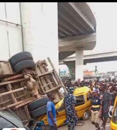 Driver severely injured as truck falls off bridge in Lagos