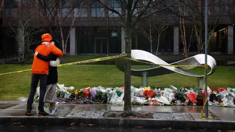Brown University places its police chief on leave after mass shooting attack