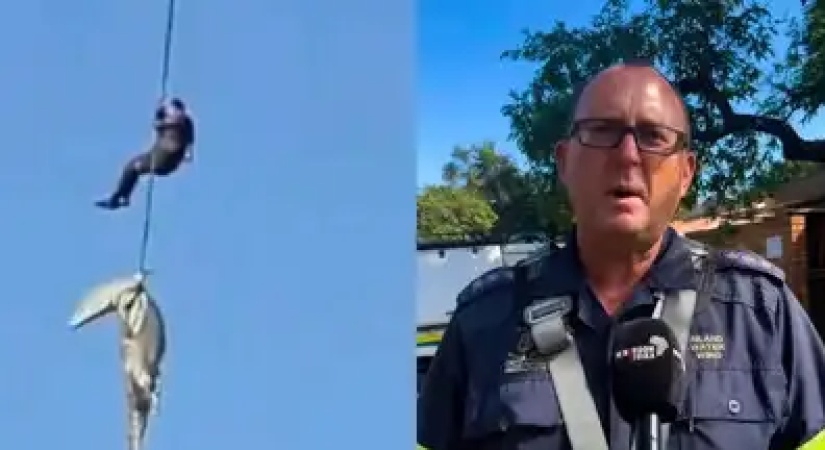 Police officer lowered into crocodile-infested river to recover human remains 