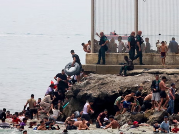 Hundreds of migrants swim from Morocco to Spanish enclave of Ceuta