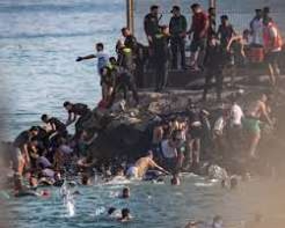 At least 18 die as thousands cross from Morocco into enclave of Ceuta