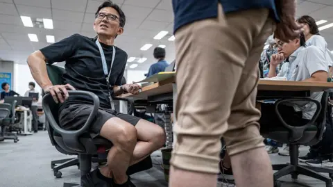 Tokyo urges men to wear shorts to work, but some women say it's 'leg hair harassment'