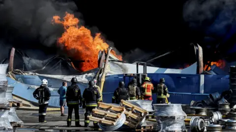 At least 37 dead and hundreds evacuated after strike on Kyiv warehouse