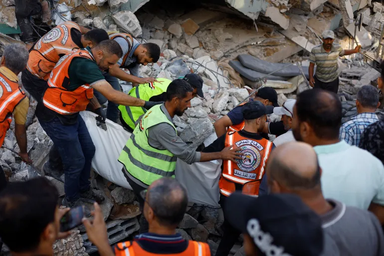Gaza building collapse kills 16, traps dozens under rubble