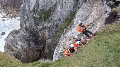 Dramatic clifftop rescue of bride and groom-to-be